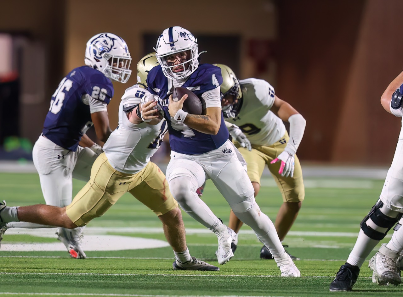 Ashton running with the football through opposing defenders