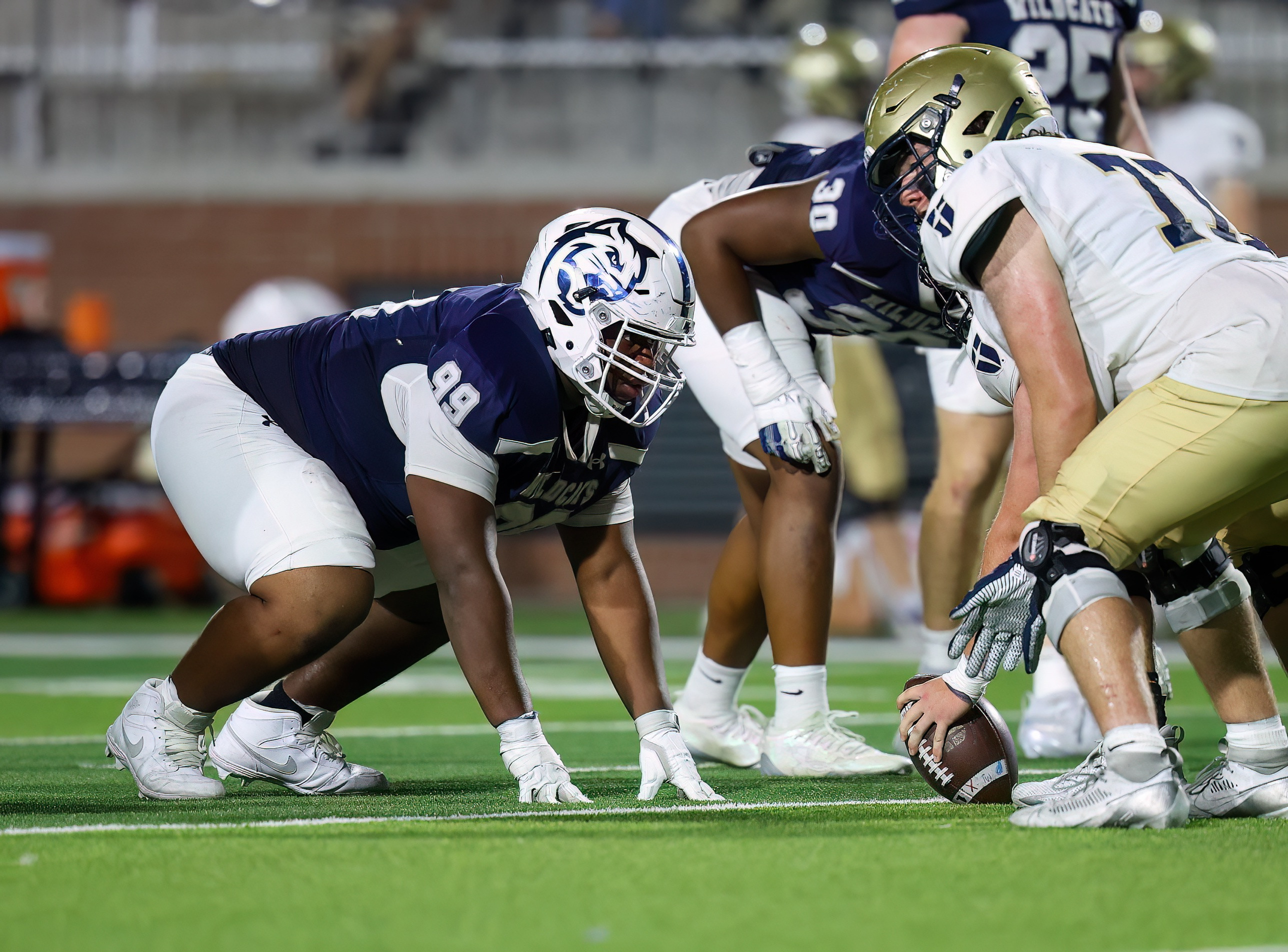 Kristopher Williams in a three-point stance over the center against Dallas Jesuit